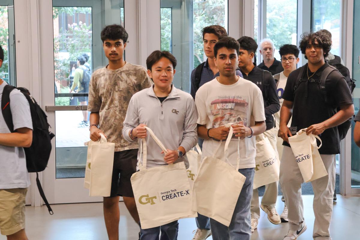 students entering the building with conference bags